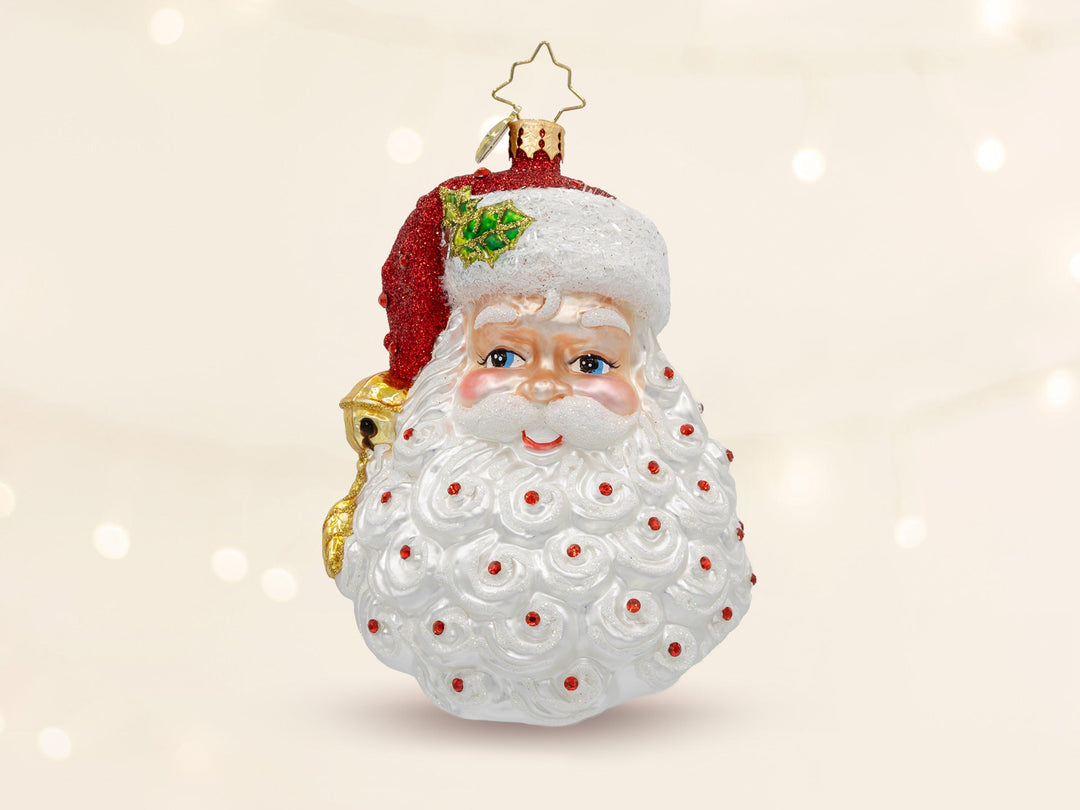 A santa head ornament with red July birthstones placed all over santa's beard.