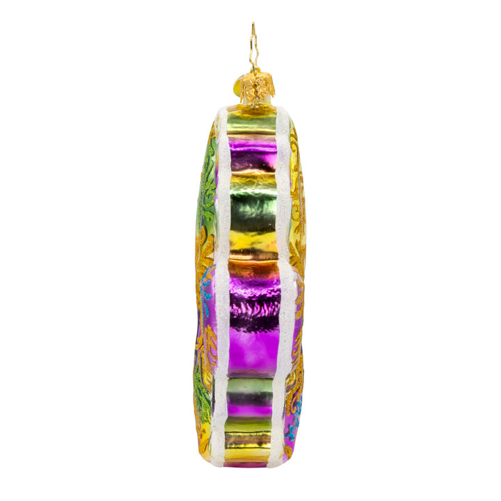 Fleur de Lis Charm Ornament. This Fleur de Lis symbol captures the essence of Mardi Gras with its dazzling design and bold colors. View of right side.