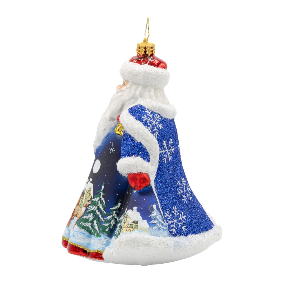 Santa of the Midnight Sky ornament. Santa dons a blue robe with a hand painted scene of him journeying through the night on Christmas Eve. View of right side.