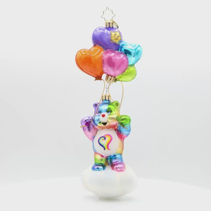 Togetherness Bear ornament. Featuring a rainbow-colored bear holding heart-shaped ballons atop a cloud. Video.