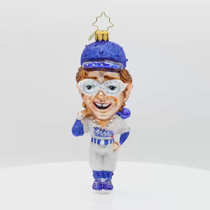 Elton's Grand Slam ornament. Featuring the iconic musician in a full-on baseball getup. Video.