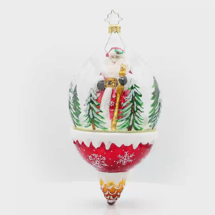 Winter Wanderlust ornament. This dome features a jolly Santa exploring a snowy forest with a playful deer. The shimmering snow, twinkling lights, and festive details create a magical atmosphere. Video.