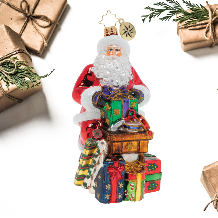 Ornament Description - Workshop Wonders: Santa is wrapping gifts for the holiday! His nimble fingers and eye for detail make him a gift wrapping extraordinaire!