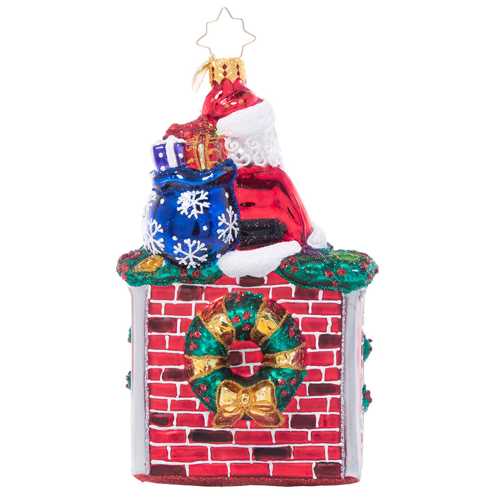 Back - Ornament Description - A Perfect Place to Perch: During a long night of making Christmas magic around the globe, even Santa needs a little break. He finds a spot to sit on the mantle of a roaring fireplace and admires his job well done!