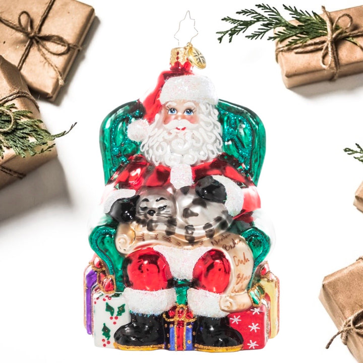 Ornament Description - Purr-fectly Relaxed: Even the kitty knows that who's lap is the best seat in the house! Santa curls up with his feline friend and relaxes in his chair as he unwinds from a busy day of Christmas magic-making.